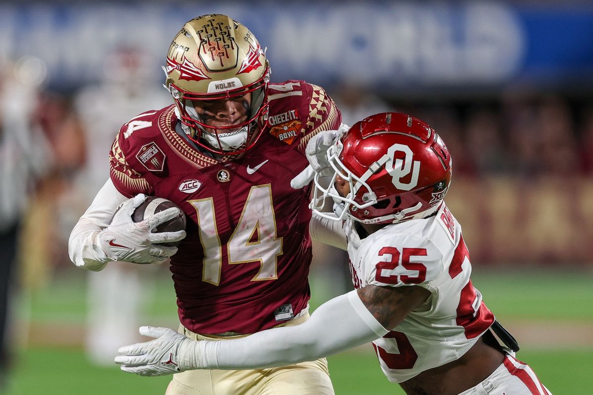 Florida State Seminoles wide receiver Johnny Wilson (14) catches a pass while defended by Oklahoma Sooners defensive back Justin Broiles (25) in the fourth quarter during the 2022 Cheez-It Bowl at Camping World Stadium. Florida State Seminoles wide receiver Johnny Wilson (14) catches a pass while defended by Oklahoma Sooners defensive back Justin Broiles (25) in the fourth quarter during the 2022 Cheez-It Bowl at Camping World Stadium.