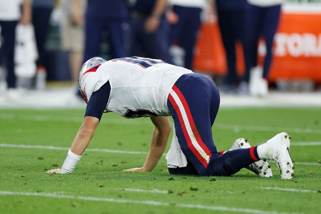 Mac Jones #10 of the New England Patriots lays on the ground after being sacked in the first half against the Green Bay Packers during a preseason game at Lambeau Field on August 19, 2023 in Green Bay, Wisconsin. Mac Jones #10 of the New England Patriots lays on the ground after being sacked in the first half against the Green Bay Packers during a preseason game at Lambeau Field on August 19, 2023 in Green Bay, Wisconsin.