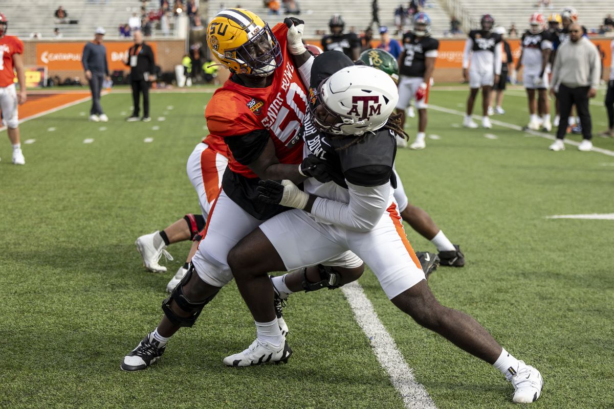 American team offensive lineman Emery Jones of LSU (50) spars with American team defensive lineman Shemar Stewart of Texas A&M (14) during Senior Bowl practice for the American team at Hancock Whitney Stadium. 