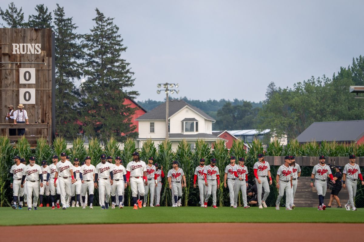 Players walk onto the field before a baseball game between the Minnesota Twins and the Philadelphia Phillies at the Field of Dreams movie site, Thursday, Aug. 13, 2026, in Dyersville, Iowa.